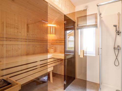 a bathroom with a shower and a glass shower stall at Holiday Home Lakeside Village 22 - - sauna by Interhome in Frymburk