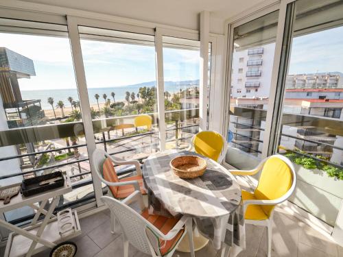 a dining room with a table and chairs on a balcony at Apartment Formentor by Interhome in Salou