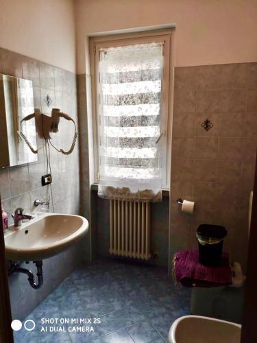 a bathroom with a sink and a window at Residence Laguna Beach in Pianello Del Lario