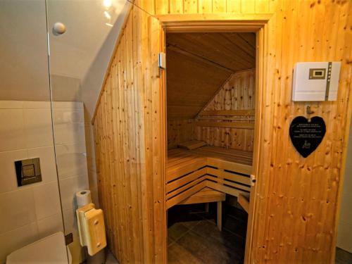 a small wooden sauna in a bathroom with a shower at Holiday Home Lakeside Village 36 - - sauna by Interhome in Frymburk
