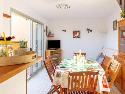 a kitchen and dining room with a table and chairs at Holiday Home Les Captivantes II-8 by Interhome in Cap d'Agde