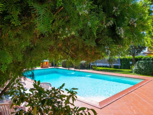 a swimming pool in a yard with trees at Chalet Del Colle by Interhome in Perugia