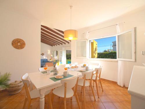 a dining room with a white table and chairs at Villa Mariana by Interhome in Galé