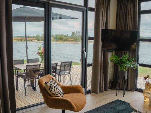 a living room with a view of the water at Holiday Home MarinaPark Bad Nederrijn-1 by Interhome in Maurik
