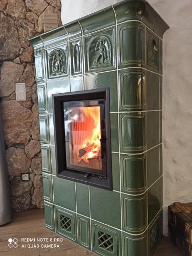 a wood burning stove in a room at Chata pod smrekmi in Hriňová