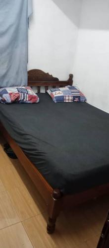 a bed with two pillows on top of it at rashitta 