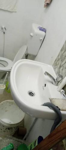 a bathroom with a white sink and a toilet at rashitta 