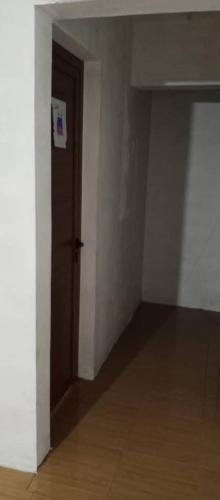 an empty room with a door and a hallway at rashitta 
