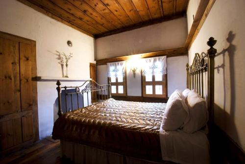 a bedroom with a bed in a room with windows at Gulevi Safranbolu in Safranbolu