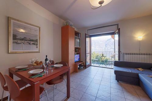 a living room with a table and a blue couch at Lake View Apartment Studio Vacation Station in Acquaseria