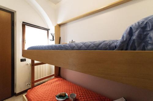 a room with two bunk beds and a red rug at Lake View Apartment Studio Vacation Station in Acquaseria