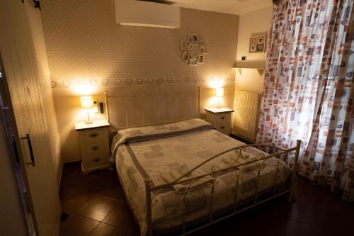 a small bedroom with a bed and two night stands at B&B TORRE AZUL FRONTEMARE - Bisceglie in Bisceglie