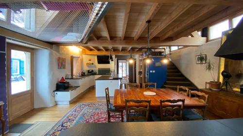 une cuisine et une salle à manger avec une table et des chaises dans l'établissement La Grange d'Emmanuel, Marsous, 6-8 pers, à Arrens-Marsous