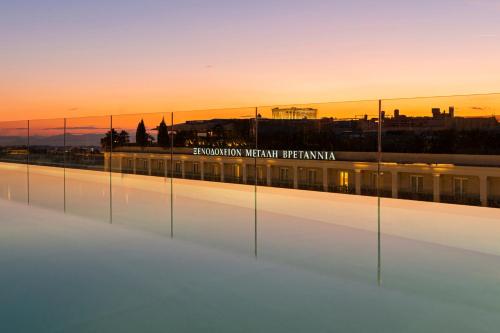 a view of a train station with a city in the background at Athens Capital Center Hotel - MGallery Collection in Athens