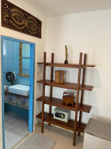 a bathroom with wooden shelves and a sink at Mesa Garden Villa in Chiang Mai