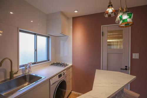 a kitchen with a sink and a washing machine at ZDT-614 in Tokyo