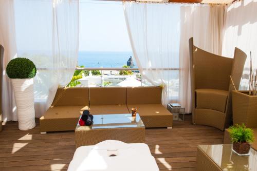 a living room with a couch and a view of the ocean at Melia Madeira Mare in Funchal