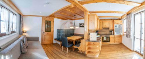 a tiny house with a kitchen and a living room at Almhof-Reithof Pitztal in Sankt Leonhard im Pitztal