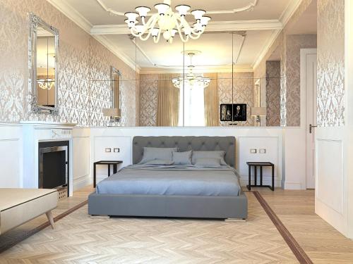 a bedroom with a large bed and a chandelier at Duomo Rooms in Milan