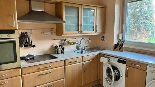 a kitchen with a sink and a washing machine at Apartment centrally located in the Rhine-Main area in Riedstadt