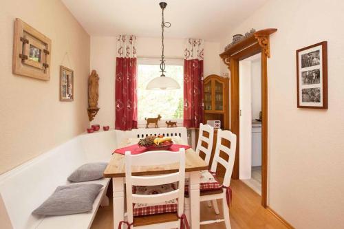 a kitchen and dining room with a table and chairs at Chalet Manhard in Pfronten