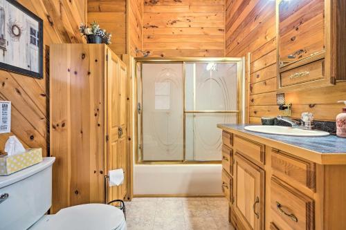 a bathroom with a toilet and a sink and a tub at Charming Austin Cabin on 96 Acres of Land! 