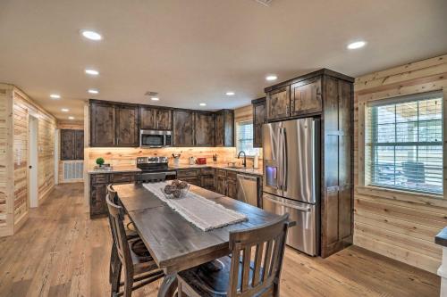 a kitchen with wooden cabinets and a wooden table at Greers Ferry Home on 40 Acres quarter Mi to Lake! in Fairfield Bay