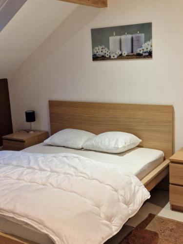 a bedroom with a large bed with white sheets at Studio Haras in Wavre