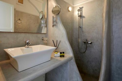 a bathroom with a sink and a shower at Marizan Caves & Villas in Oia