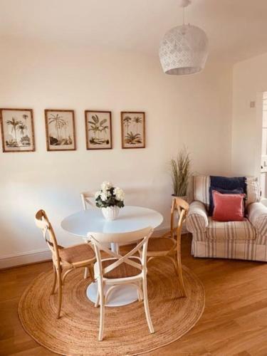 a living room with a table and chairs and a couch at Cosy Bungalow with a view in Lincoln