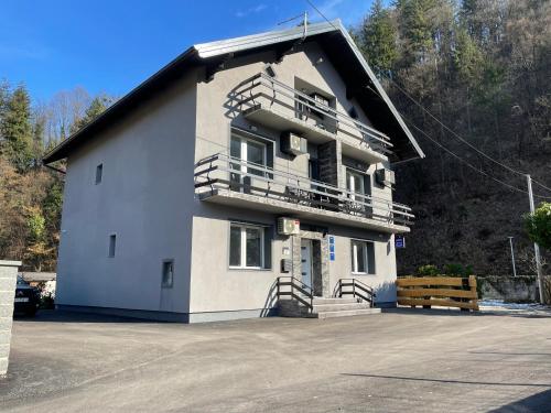 a large white building with stairs and a balcony at Apartmani "Stari Grad - Samobor" in Samobor