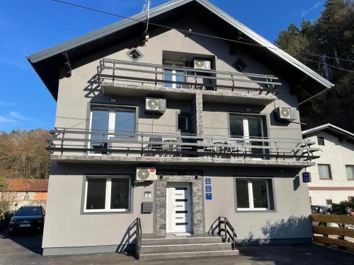 a house with a balcony on top of it at Apartmani "Stari Grad - Samobor" in Samobor