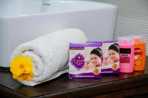 a towel and two products on a bathroom counter at Manike Lodge Habarana in Habarana