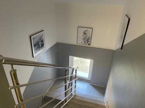 a staircase in a house with two pictures on the wall at Apartmani "Stari Grad - Samobor" in Samobor
