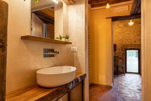 a bathroom with a large white sink on a counter at Casa di Campagna in Colle Val D'Elsa
