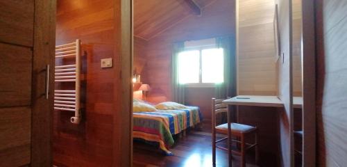a small bedroom with a bed and a window at VILLA ANGELINI in Valle-di-Campoloro