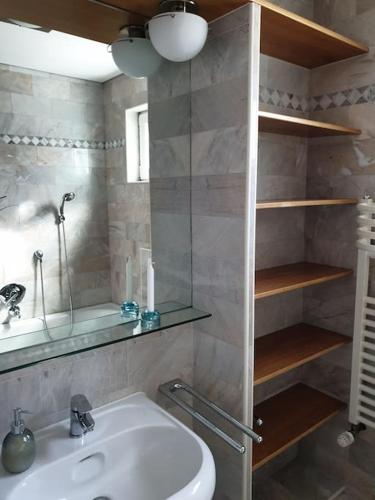 a bathroom with a white sink and a mirror at 16 Personen Harzhaus für Gruppen in Clausthal-Zellerfeld in Clausthal-Zellerfeld