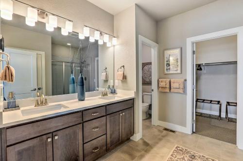a bathroom with two sinks and a large mirror at Mountain-View Granby Retreat on Golf Course! in Granby