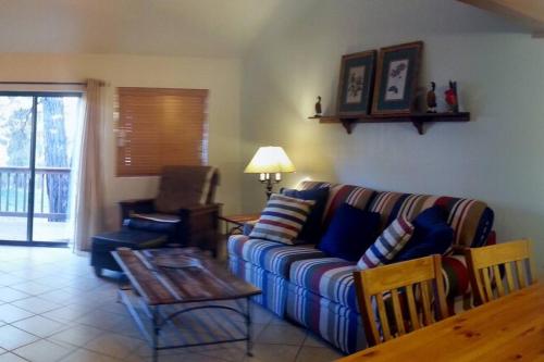a living room with a couch and a table at Cozy Flagstaff Home in Cool Pines - Country Club in Flagstaff