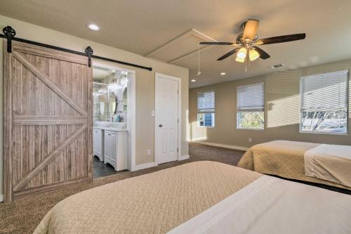 a bedroom with a barn door and a ceiling fan at San Antonio Home with Deck, 6 Mi to Downtown! in San Antonio