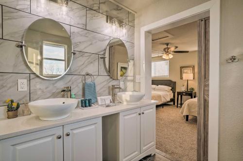 a bathroom with two sinks and a large mirror at San Antonio Home with Deck, 6 Mi to Downtown! in San Antonio