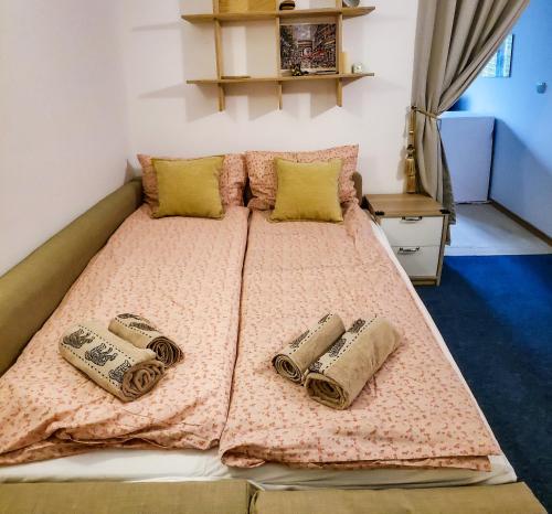 a bed with a pink blanket and pillows on it at Apart 32 Govedartsi Forest View in Govedartsi
