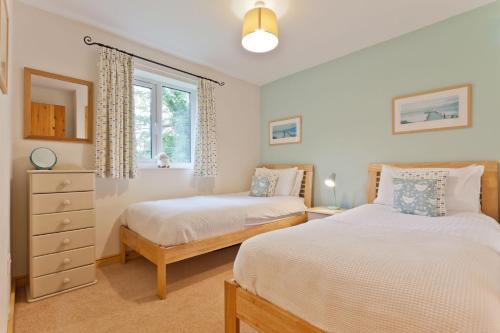 a bedroom with two beds and a window at Yewdale Cottage Coniston in Coniston