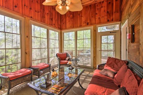 a living room with a couch and a table at Lakefront South Carolina Abode with Deck and Boat Dock in Fair Play