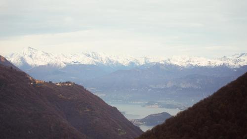 a view of a mountain range with snow covered mountains at Panoramic lake view home's Giulia in Casasco Intelvi