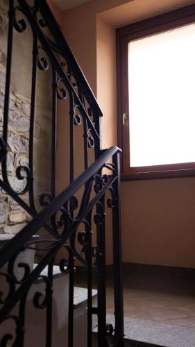 a stairway with a window and a stair railing at Panoramic lake view home's Giulia in Casasco Intelvi