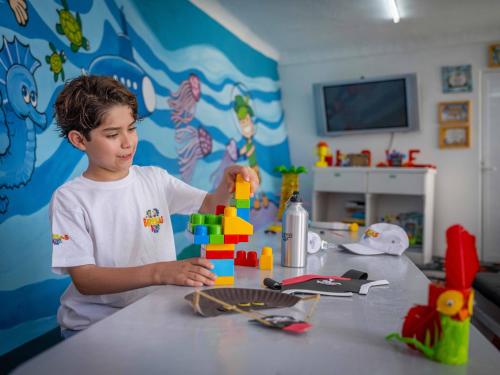 a young boy playing with toys at a table at Las Hadas by Brisas in Manzanillo