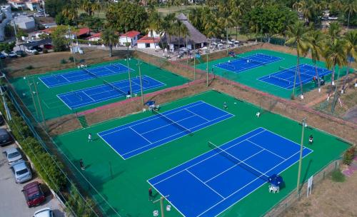an overhead view of two tennis courts with palm trees at Las Hadas by Brisas in Manzanillo