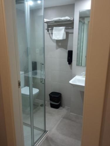 a bathroom with a glass shower and a toilet at Hotel Estrella Del Mar in Motril