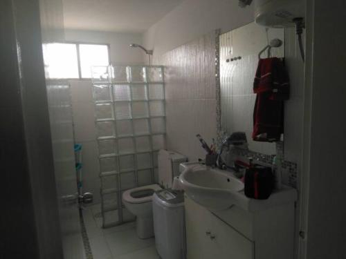 a bathroom with a toilet and a sink and a shower at La Casa De Rosa in Montevideo